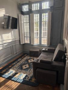 a living room with a couch and a tv at Familyhostel in Santiago