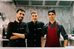 a group of three men standing in a kitchen at Mish Mish in Tamraght Ouzdar