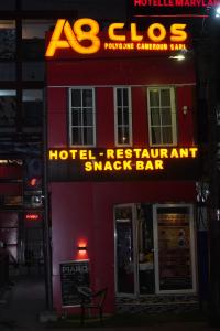 a sign for a hotel restaurantasy bar on a building at Complexe A8CLOS in Douala