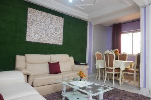 a living room with a couch and a table at Complexe A8CLOS in Douala