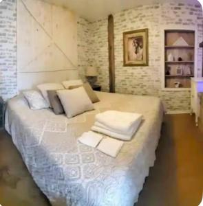 a large bed with white sheets and pillows on it at The Hideaway in North Canton