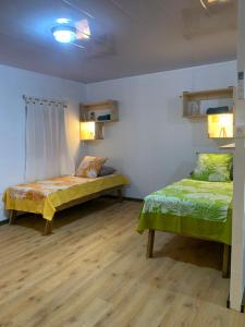 a bedroom with two beds in a room at Kura Ora Guest House in Rangiroa