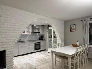 a kitchen with a white table and a dining room at Siam Homestay in Mölndal