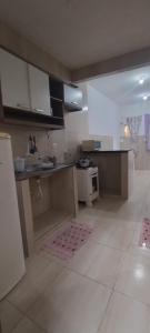 a kitchen with white cabinets and a counter top at Kitnet na Imbiribeira in Recife +26 photos