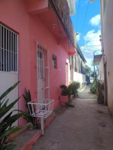 a pink building with a gate on the side of it at Kitnet na Imbiribeira in Recife