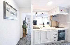 a kitchen with white cabinets and a sink at Marisol Molina in Sueca