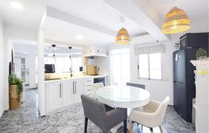a kitchen with a white table and chairs in it at Marisol Molina in Sueca