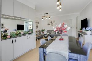 a dining room and living room with a table and chairs at The Modern Retreat in Sydney
