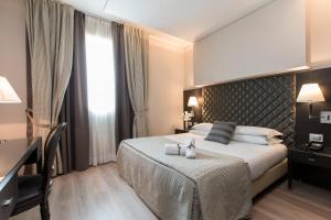 Кровать или кровати в номере Just Hotel Lomazzo Fiera