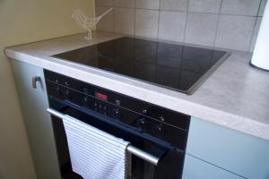 a kitchen with a stove top oven with a towel at Apartments in Kauguri in Jūrmala