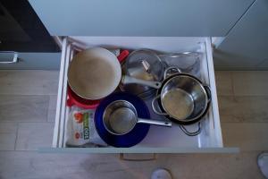 a bunch of pots and pans in a refrigerator at Apartments in Kauguri in Jūrmala +14 photos