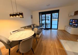 a living room with a table and a couch at Apartman TERRASSE in Trebinje