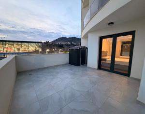 a large balcony with a view of a building at Apartman TERRASSE in Trebinje