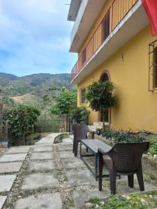 a patio with chairs and a table in front of a building at Casa El Limón in Yelapa