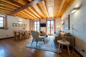 a living room with a couch and a table at Limonaia dei Dogi Entire 7BR Villa with Private Pool & Lake Garda View in Gargnano