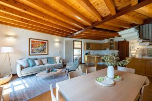 a living room with a wooden ceiling at Limonaia dei Dogi Entire 7BR Villa with Private Pool & Lake Garda View in Gargnano