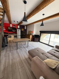 a living room with a couch and a table at L'atelier in Capestang