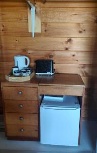 a kitchen with a wooden counter top with a stove at Riverside Loft in Turangi