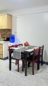 a kitchen with a table and chairs with a table and a table at Mr B Guest House Room Rentals in San Fernando, Cebu in San Fernando