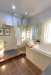 a bathroom with a shower and a sink and a toilet at Khu Hòa Bình in Da Lat