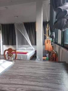 a room with a table and two beds in it at Estudio La Higuera in Yelapa