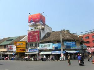 a city street with a group of buildings and people at Khu Hòa Bình in Da Lat +2 photos