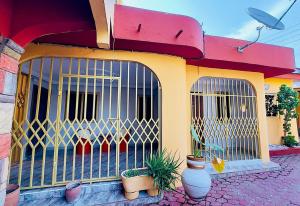 a building with a gate with plants in it at Villa de chez nous in North Legon