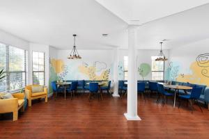 a dining room with blue chairs and tables at Grand 6BR 3BA Pool Escape Round Rock in Round Rock