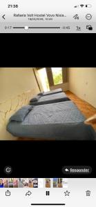 a television screen with a bed in a room at MGerais Pousada in Visconde do Rio Branco
