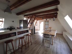 a kitchen with a table and chairs in a room at Mon petit chalet in Puycornet