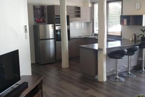a kitchen with stainless steel appliances and wooden floors at Gympie Townhouse in Gympie