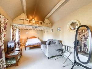 a living room with a couch and a bed at Oaklands Farm - Cottage 4 in Broughton