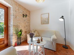 a living room with a couch and a table at Charming Villa with Private Garden & BBQ in Barban +32 photos