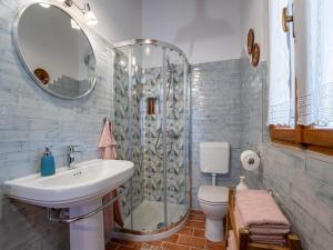 a bathroom with a sink and a shower and a toilet at Charming Villa with Private Garden & BBQ in Barban