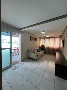 a living room with a couch and a table at Vista Real - cobertura com 160m2 - Piscina privada in João Pessoa