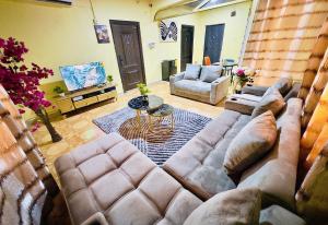 a living room with a couch and a table at Villa de chez nous in North Legon