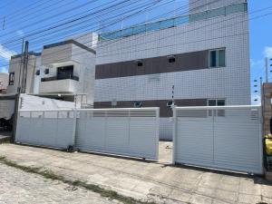 a building with two gates in front of a building at Vista Real - cobertura com 160m2 - Piscina privada in João Pessoa