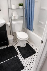 a bathroom with a white toilet and a shower at Carson in Carson +21 photos