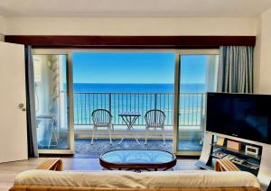 a living room with a view of the ocean at Ajisai Coral Princess Villa in Shirahama