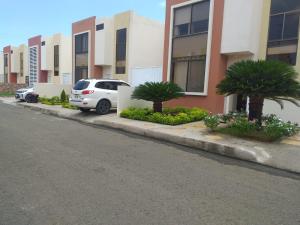 a white car parked on the side of a street at Urbanization Maratea in Manta