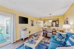 a living room with a blue couch and a table at AVPP4 Sunset Terrace in Avon