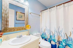 a bathroom with a sink and a toilet and a shower curtain at AVPP4 Sunset Terrace in Avon +17 photos