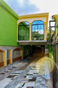 an empty courtyard of a green building at Coke Guest House in Mandeville