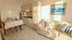 a living room with a couch and a table at Cavour Apartment With Terrace in Palau