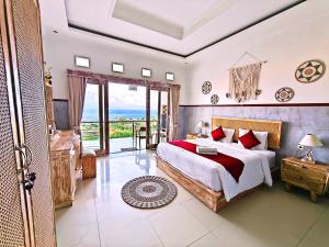 a bedroom with a bed and a view of the ocean at Darya Sea View by ABM in Nusa Penida