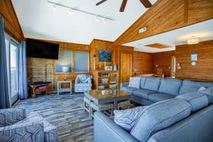 a living room with blue couches and a flat screen tv at AVWI1 Beach Stars #1-WI in Avon