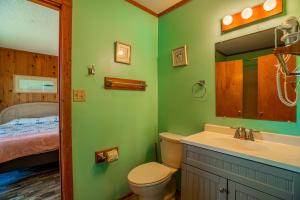a bathroom with a toilet and a sink and a bed at AVWI1 Beach Stars #1-WI in Avon +21 photos