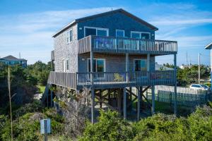 a house with a deck on the beach at AVWI1 Beach Stars #1-WI in Avon