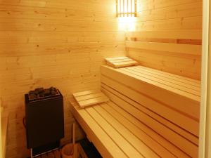 a sauna with wooden paneled walls and wooden floors at Group Villa with Pool & Sauna in Wanze