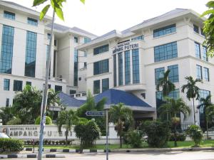 a building with a street sign in front of it at Palm Inn Ampang Point in Ampang